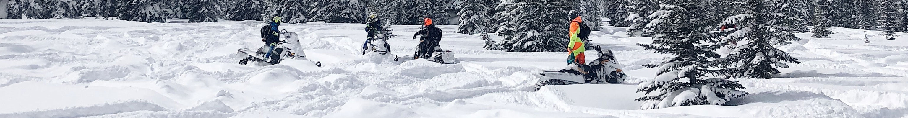 Snowmobilers take a break on a long trip
